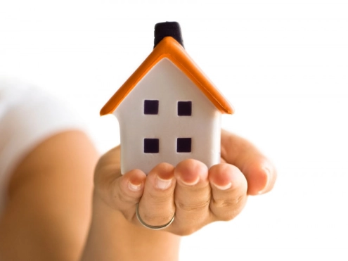 image of a new homeowner receiving keys from a real estate agent